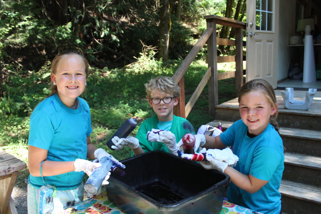 Campers dye their cotton t-shirts during a Tie-Dye activity