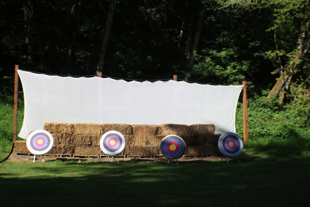 A view of the archery range, which shows four targets with hay bales behind them